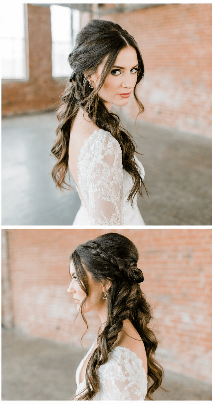 Bridal portrait in an industrial loft, featuring a bride with a half-up hairstyle of smooth waves and hidden Dutch braids, illuminated by afternoon light against exposed brick walls.