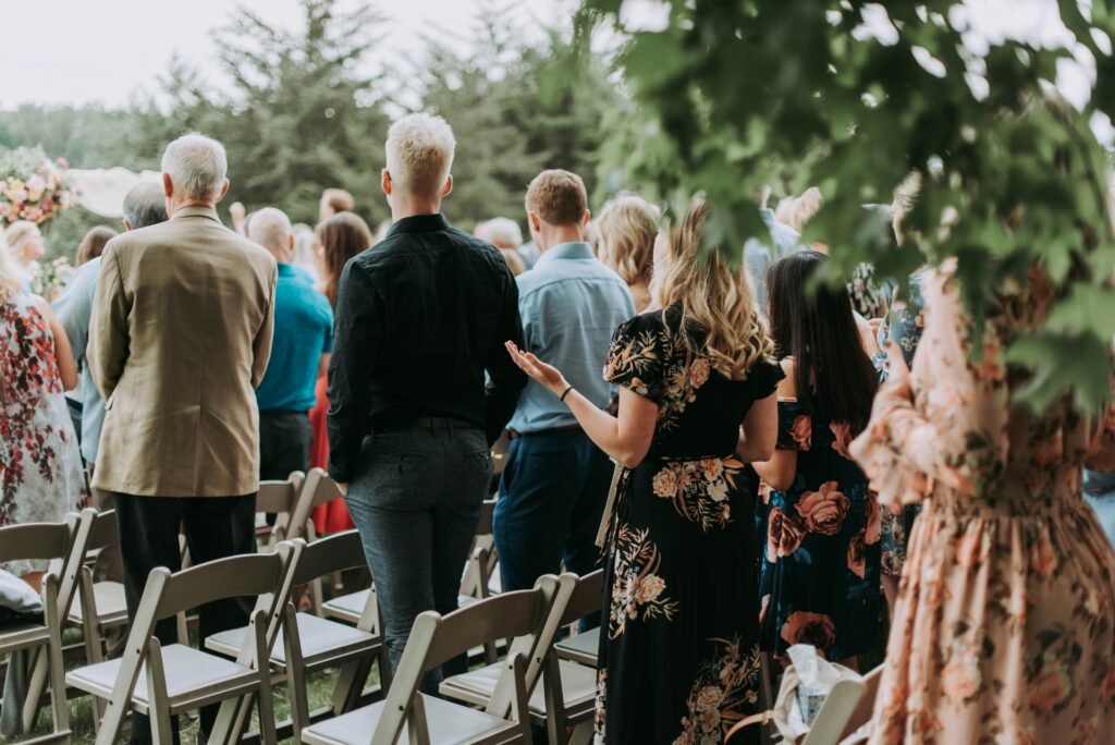 What to Wear to a Wedding? wedding guests mingling at an outdoor garden ceremony
